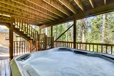 a screened in porch with a hot tub on a deck at Cold Springs Mountain Cabin Hot Tub and Generator in Cold Springs