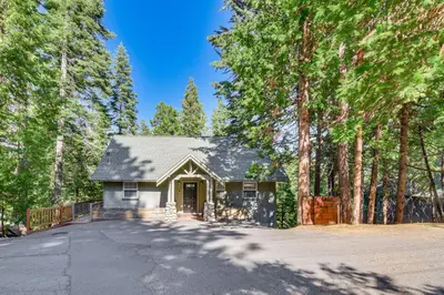 a house in the woods with a driveway at Cold Springs Mountain Cabin Hot Tub and Generator in Cold Springs