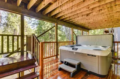 a barbecue on a screened in porch of a house at Cold Springs Mountain Cabin Hot Tub and Generator in Cold Springs