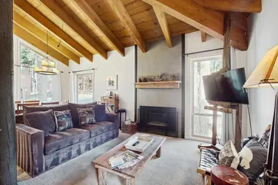 a living room with a couch and a fireplace at Golf Club Condos #437 in Truckee