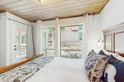 a bedroom with a bed and a window at Golf Club Condos #437 in Truckee