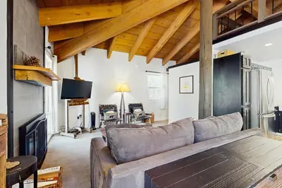a living room with a couch and a fireplace at Golf Club Condos #437 in Truckee