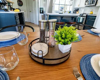 a dining room table with a table set with plates and glasses at Secluded Mtn Top Family Haven w/Views Spa & Arcade in Three Rivers