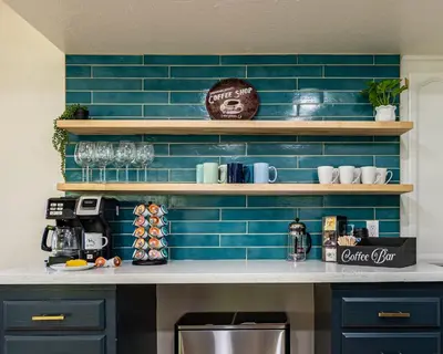 a kitchen with blue tiled walls and a counter top at Secluded Mtn Top Family Haven w/Views Spa & Arcade in Three Rivers