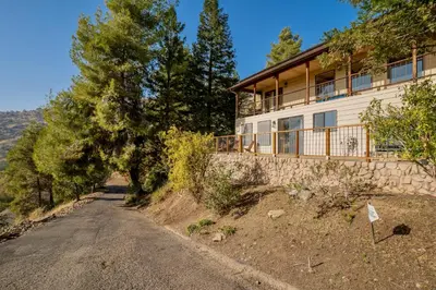 a house on the side of a dirt road at Secluded Mtn Top Family Haven w/Views Spa & Arcade in Three Rivers