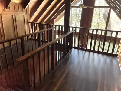 a wooden staircase in a cabin with a window at Megans Mountain Getaway in Miramonte