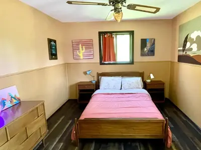 a bedroom with a bed and a ceiling fan at Megans Mountain Getaway in Miramonte