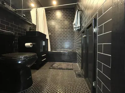 a black bathroom with a toilet and a shower at Megans Mountain Getaway in Miramonte