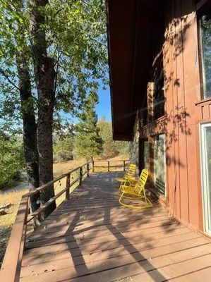 two yellow chairs sitting on a porch of a house at Megans Mountain Getaway in Miramonte