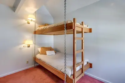 a bunk bed in a room with a swing at Walk to the Lake - Ski in out Amazing 5 Bdrm - VH#343 in Bear Valley