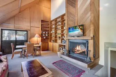 a living room with a fireplace and a tv at Walk to the Lake - Ski in out Amazing 5 Bdrm - VH#343 in Bear Valley