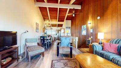 a living room with a couch and chairs and a table at Mammoth Point #106 condo in Mammoth Lakes