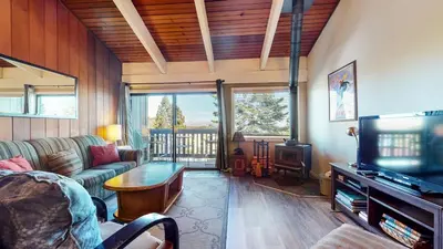 a living room with a couch and a television at Mammoth Point #106 condo in Mammoth Lakes