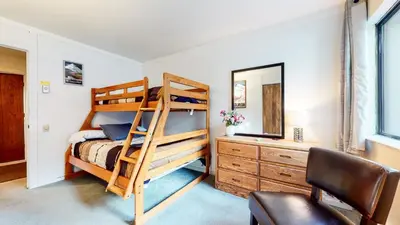 a bedroom with a bunk bed and a mirror at Mammoth Point #106 condo in Mammoth Lakes
