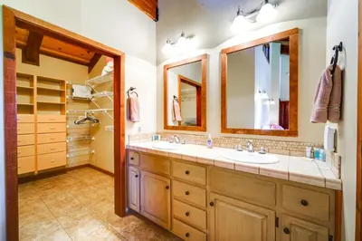 a bathroom with two sinks and two mirrors at Shuttle to Ski Resort Northstar Home! in Truckee