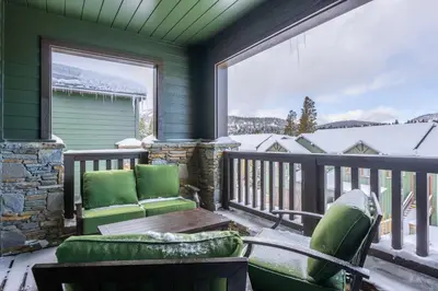 a porch with two chairs and a table and a window at Newly Built Updated 3 Bed 2 and a half bath Creekhouse at Snowcrk Resort 1463 Amazing Mountain Views in Mammoth Lakes