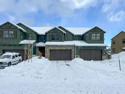 a green house with snow on top of it at Newly Built Updated 3 Bed 2 and a half bath Creekhouse at Snowcrk Resort 1463 Amazing Mountain Views in Mammoth Lakes