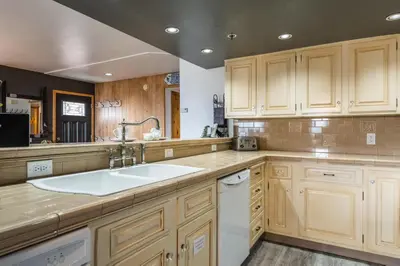 a kitchen with wooden cabinets and a sink at Bridges 112 in Mammoth Lakes