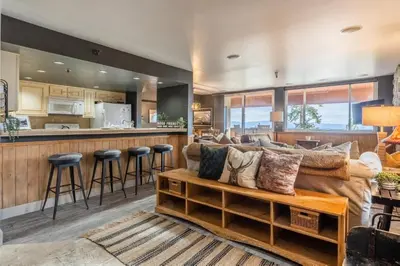 a living room with a couch and a bar at Bridges 112 in Mammoth Lakes