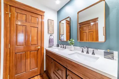 a bathroom with a sink and a wooden door at Mammoth Estates 210 in Mammoth Lakes