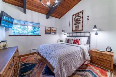 a bedroom with a bed and a wooden ceiling at Mammoth Estates 210 in Mammoth Lakes