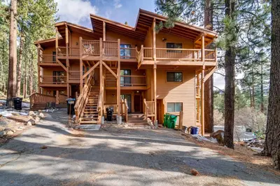 a large wooden house in the woods with a staircase at Less Than 3 Mi to Lake Tahoe Incline Village Condo! in Incline Village