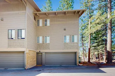 a house with two garage doors and trees at Retreat at Oriole Way in Incline Village