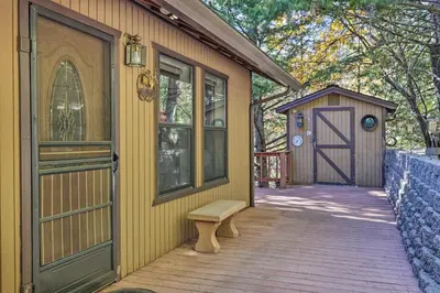 a house with a door and a bench on a porch at Deck with Forest Views Quiet Twain Harte Cabin! in Twain Harte