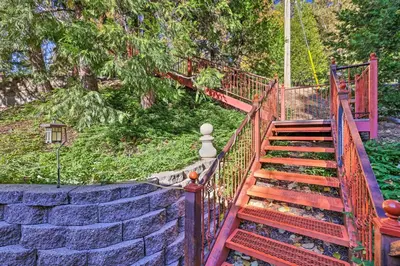 a set of stairs leading up to a stone wall at Deck with Forest Views Quiet Twain Harte Cabin! in Twain Harte