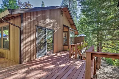 a cabin with a deck and a porch at Deck with Forest Views Quiet Twain Harte Cabin! in Twain Harte