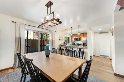 a dining room and kitchen with a wooden table and chairs at Lake Forest Drive Retreat in Tahoe City