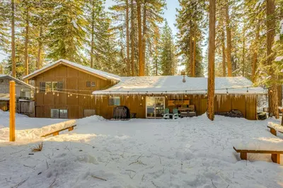 a cabin in the woods with snow on the ground at Comfort is Key Cabin in Incline Village