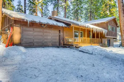 a house with a garage in the snow at Comfort is Key Cabin in Incline Village