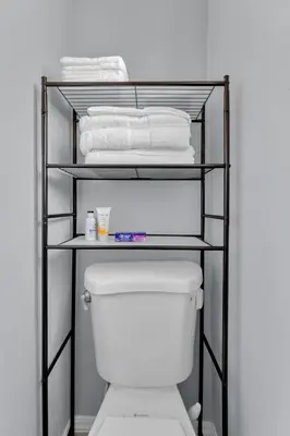 a towel rack over a toilet in a bathroom at A Cottage - Walk to UC Davis & Shriners in Sacramento