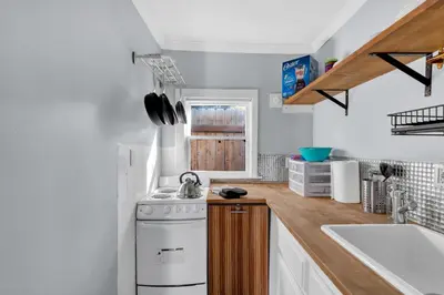 a kitchen with a stove and a sink at A Cottage - Walk to UC Davis & Shriners in Sacramento