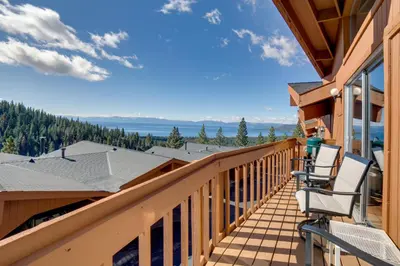 a balcony with chairs and a view of the water at Steps to Diamond Peak Incline Village Condo in Incline Village