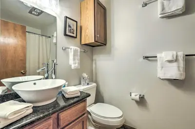 a bathroom with a sink and a toilet and a mirror at Steps to Diamond Peak Incline Village Condo in Incline Village