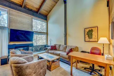a living room with a couch and a table at Northstar's Cozy Condo in Truckee