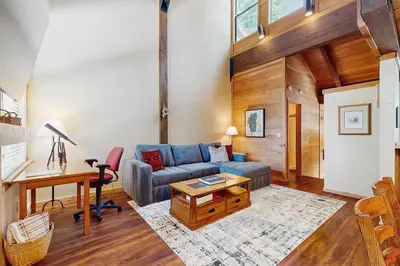a living room with a couch and a table at Northstar's Cozy Condo in Truckee
