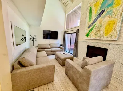 a living room with a couch and a fireplace at Walk to Canyon Lodge! Ski back! Modern Space in Mammoth Lakes