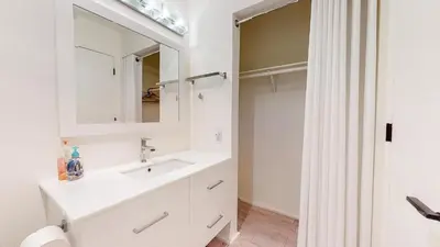 a white bathroom with a sink and a mirror at Walk to Canyon Lodge! Ski back! Modern Space in Mammoth Lakes