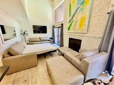 a living room with a couch and a fireplace at Walk to Canyon Lodge! Ski back! Modern Space in Mammoth Lakes