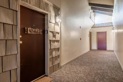 an empty hallway with a door and a hallwayngth at Mammoth Ski and Racquet 71 in Mammoth Lakes