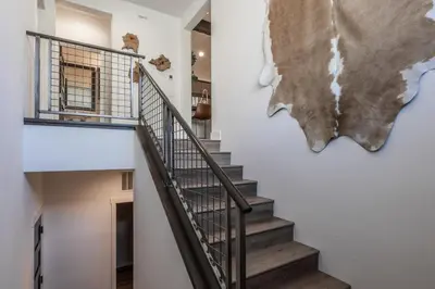 a staircase in a house with a painting on the wall at Creekhouse 1551 in Mammoth Lakes