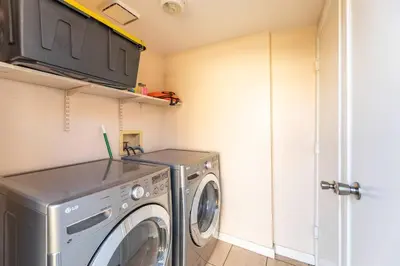 a laundry room with a washer and dryer at A+ 2 BR Victorian Home away from Home in Sacramento