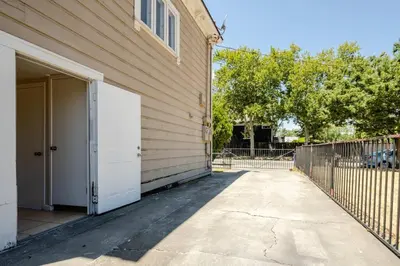a building with a white door and a fence at *2bdr Victorian Home away from Home - *Central Loc in Sacramento