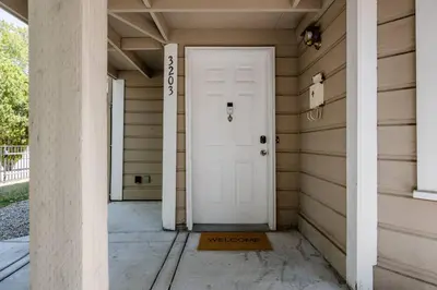 a white door on the side of a house at *2bdr Victorian Home away from Home - *Central Loc in Sacramento