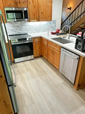 a kitchen with wooden cabinets and stainless steel appliances at Lake Tahoe Leisure in Carnelian Bay