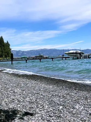 a beach with a pier in the water at Lake Tahoe Leisure in Carnelian Bay