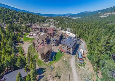 an aerial view of a large house in the woods at Cozy Northstar Village Family Condo Walk to Lifts 2 Full BA Excellent Location in Truckee